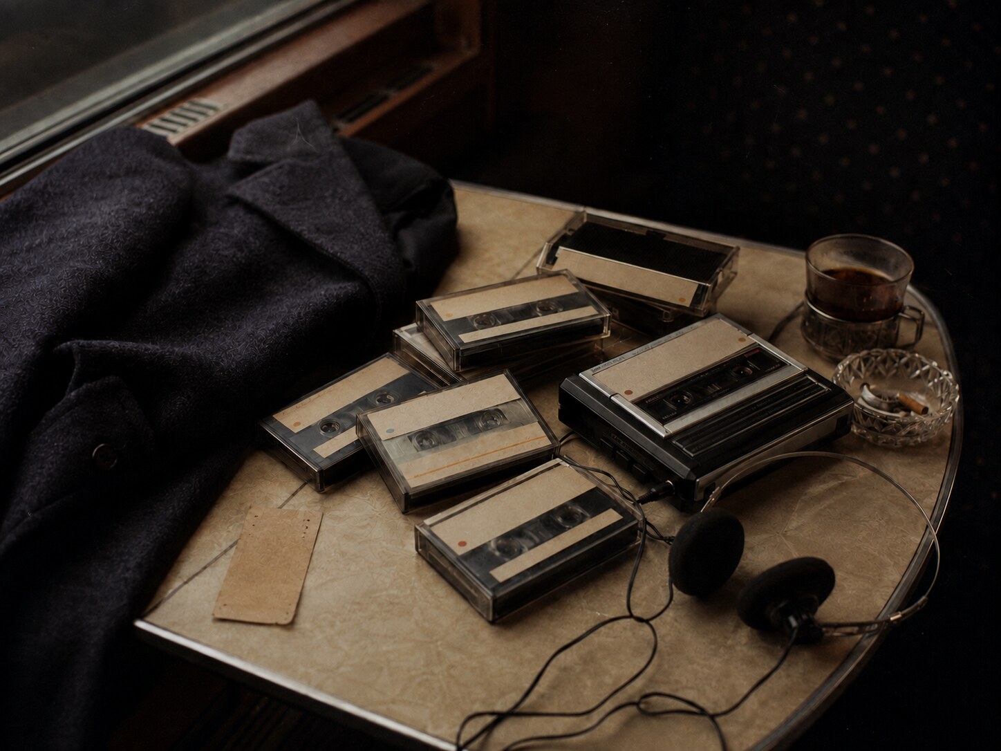 Turkish cassette tapes, handwritten labels and a portable player on a patterned cloth
