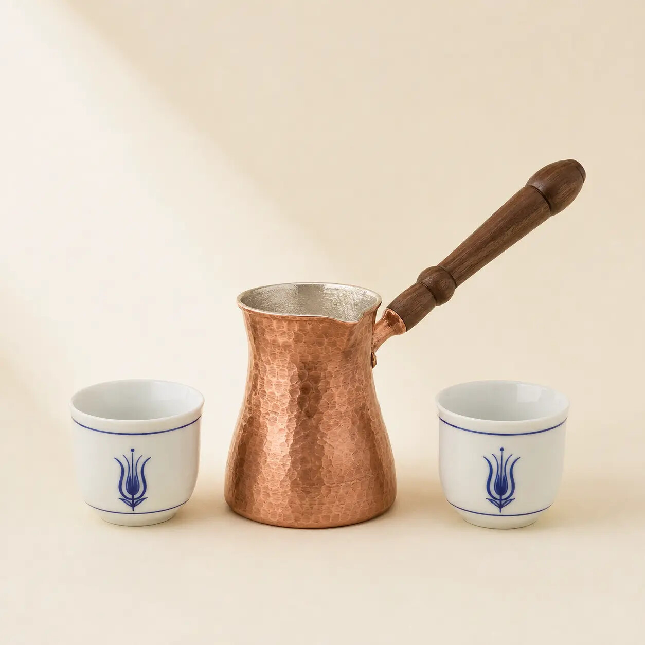 Hammered copper cezve and two porcelain coffee cups