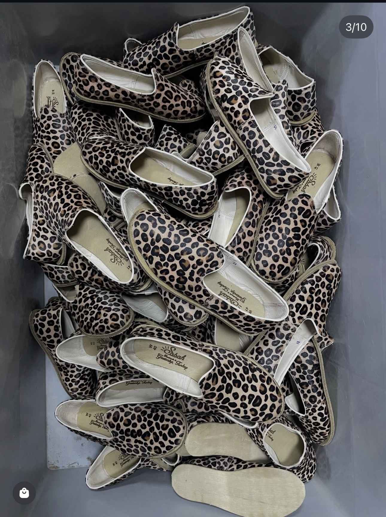 Leopard-pattern leather yemenis in a workshop crate