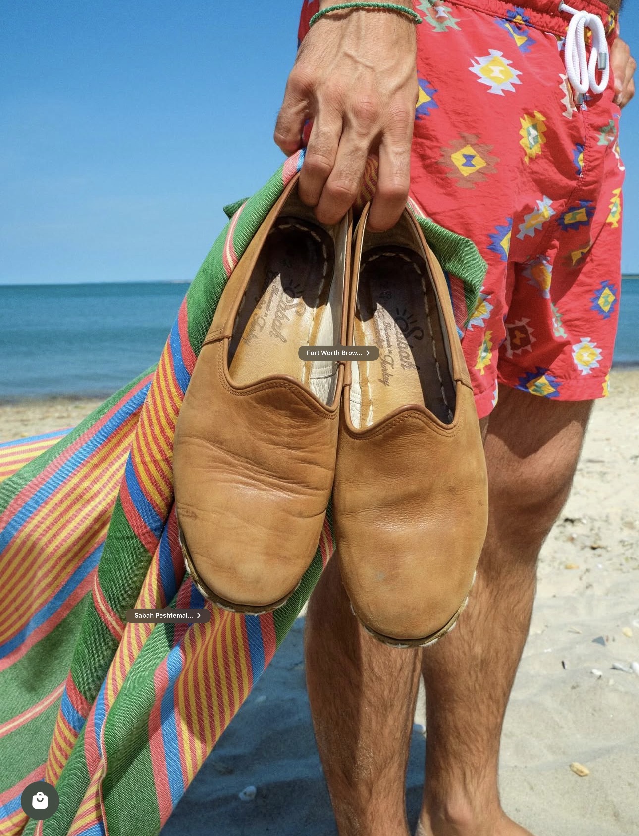 Worn tobacco leather yemenis by the sea